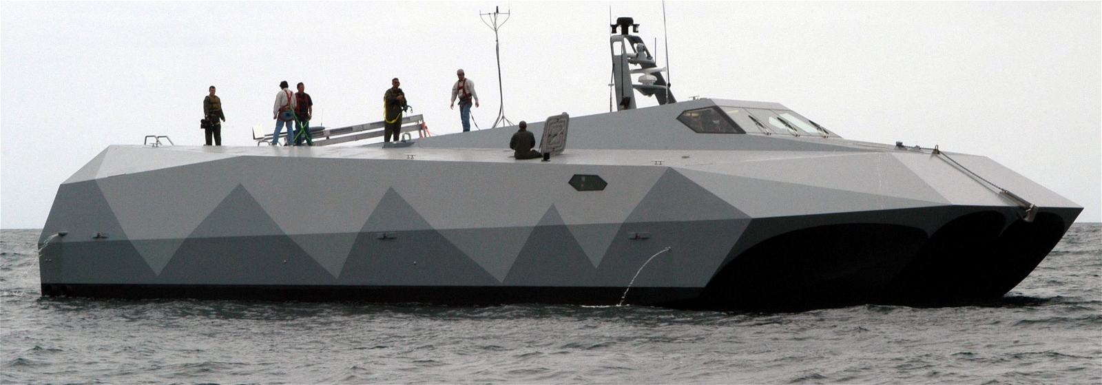 Side view of Stiletto ship with several people on board
