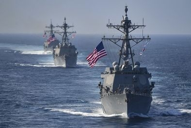 Line of warships with American flag